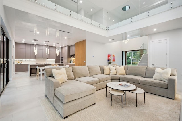 tiled living room featuring a towering ceiling