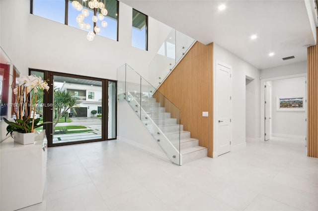 entrance foyer with light tile patterned floors and a wealth of natural light