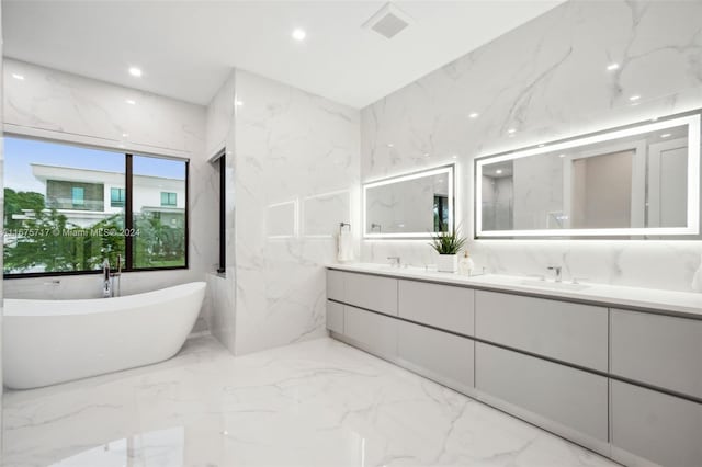 bathroom with vanity and a tub to relax in