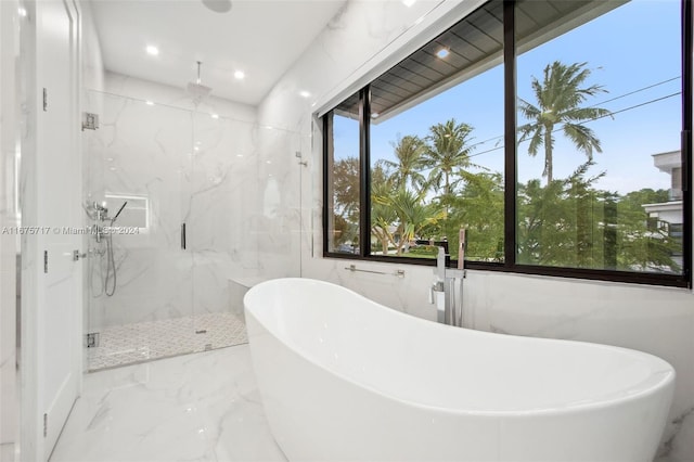 bathroom featuring shower with separate bathtub