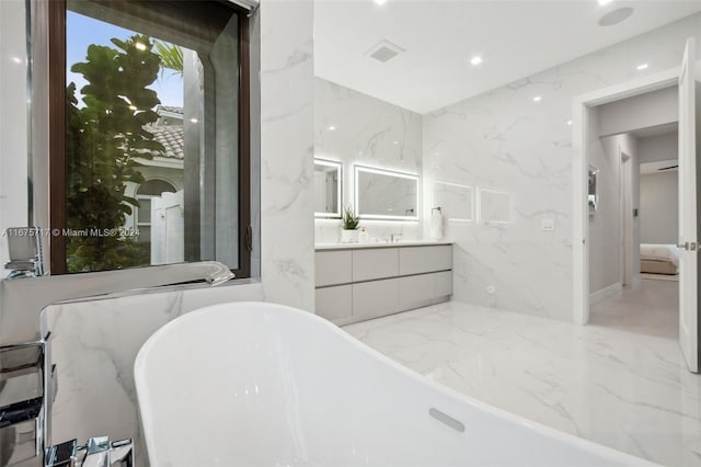 bathroom with vanity and a tub