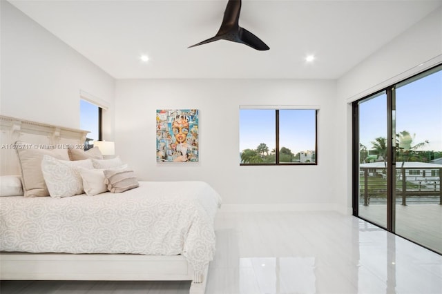 bedroom with ceiling fan, multiple windows, and access to exterior