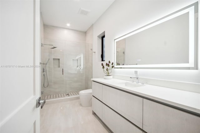 bathroom featuring vanity, toilet, and an enclosed shower