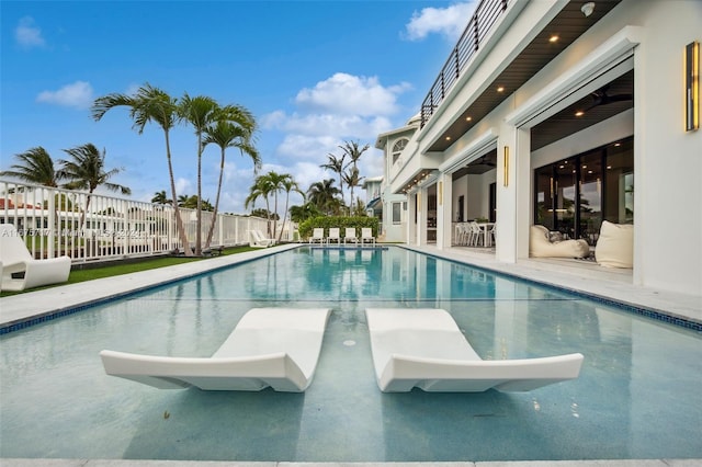 view of pool with a water slide and a patio