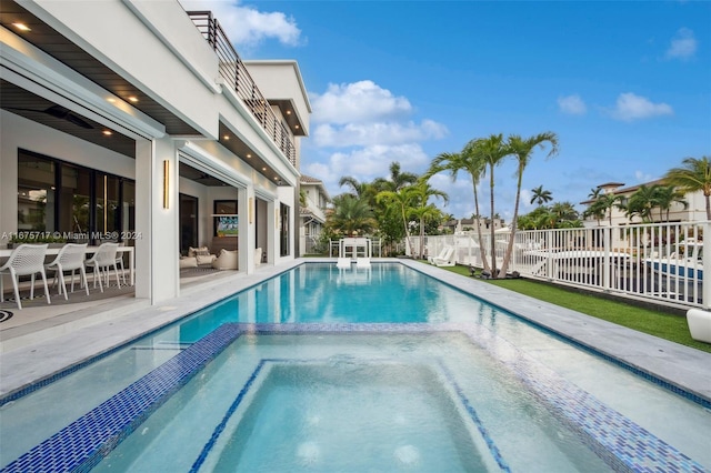 view of pool featuring an in ground hot tub and a patio area