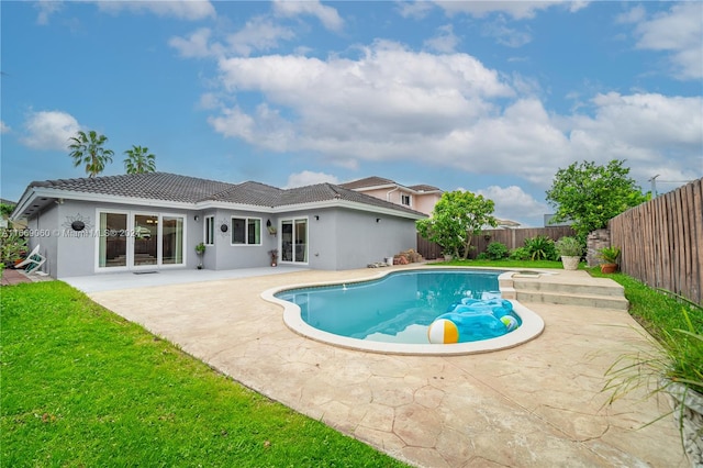 view of swimming pool featuring a yard and a patio