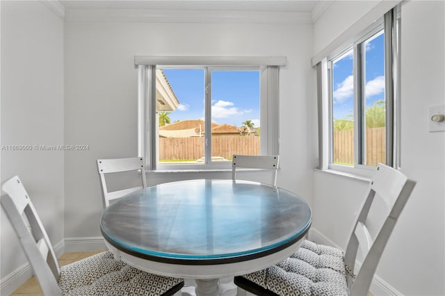 dining room featuring ornamental molding, a wealth of natural light, and light tile patterned flooring