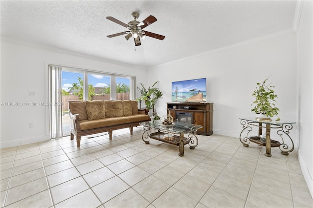 tiled living room featuring a textured ceiling, ceiling fan, and crown molding