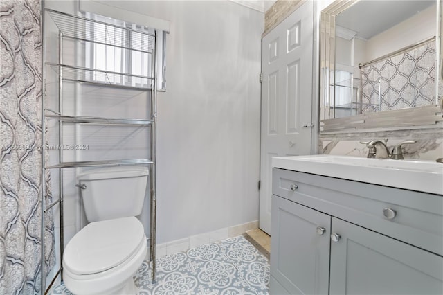 bathroom featuring vanity, tile patterned floors, and toilet