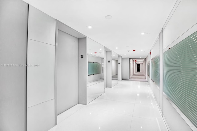 hall with light tile patterned floors