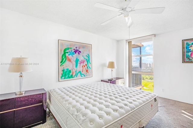 bedroom featuring carpet, a textured ceiling, and ceiling fan