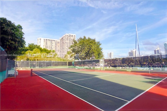 500 Three Islands Blvd Unit 116, Hallandale Beach, FL 33009 - view of tennis court with fence and a view of city