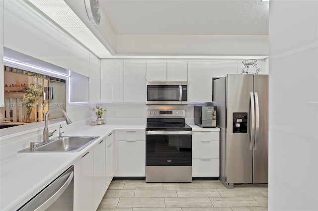 kitchen featuring white cabinets, sink, and appliances with stainless steel finishes