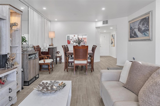 interior space featuring light wood-style floors, recessed lighting, visible vents, and baseboards