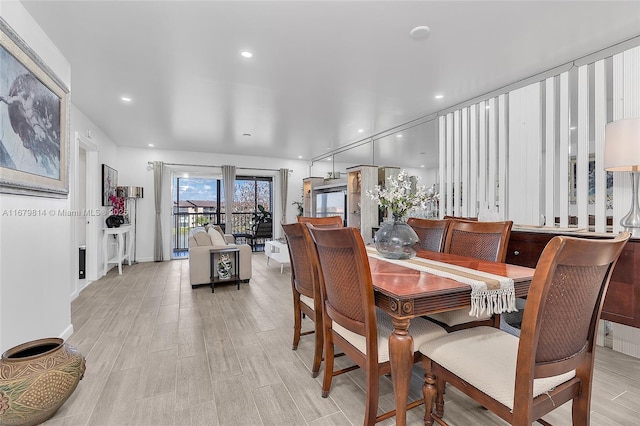 dining area featuring light wood finished floors and recessed lighting