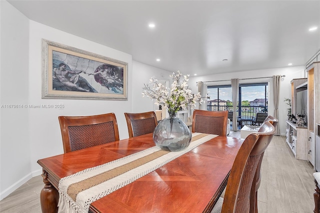 dining room with baseboards and recessed lighting