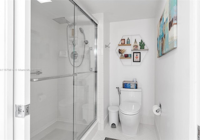 bathroom with a stall shower, tile patterned flooring, toilet, and baseboards