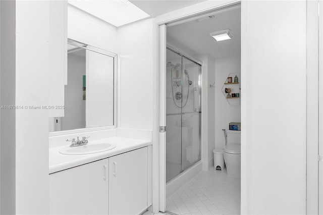 full bathroom featuring toilet, tile patterned floors, a shower stall, and vanity