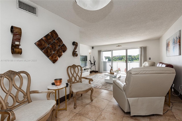 living room featuring light tile patterned floors and a textured ceiling