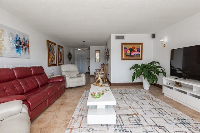 tiled living room with built in features and a textured ceiling
