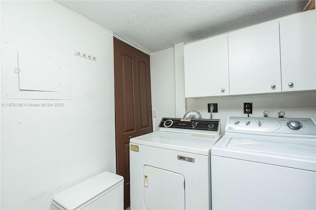 clothes washing area featuring cabinets, washing machine and dryer, and a textured ceiling
