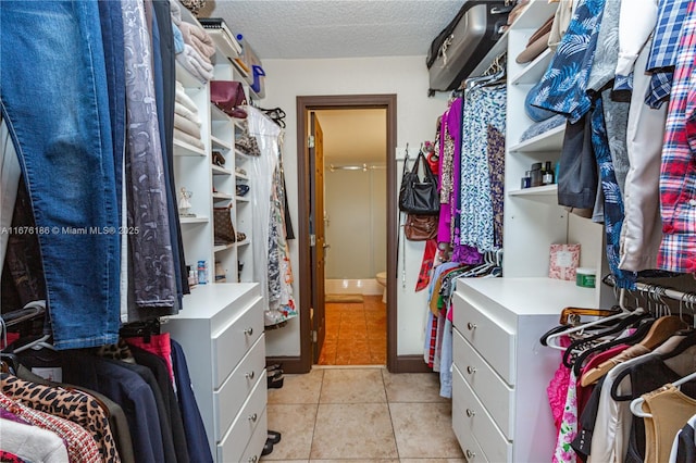 spacious closet with light tile patterned floors