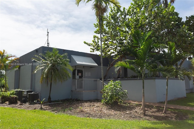 view of side of home featuring central AC unit