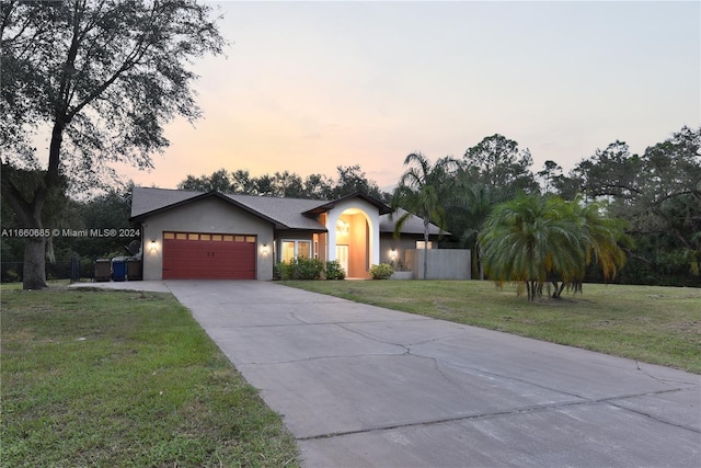 view of front of house with a lawn and a garage