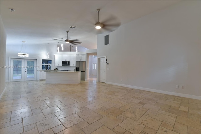 unfurnished living room with french doors and ceiling fan