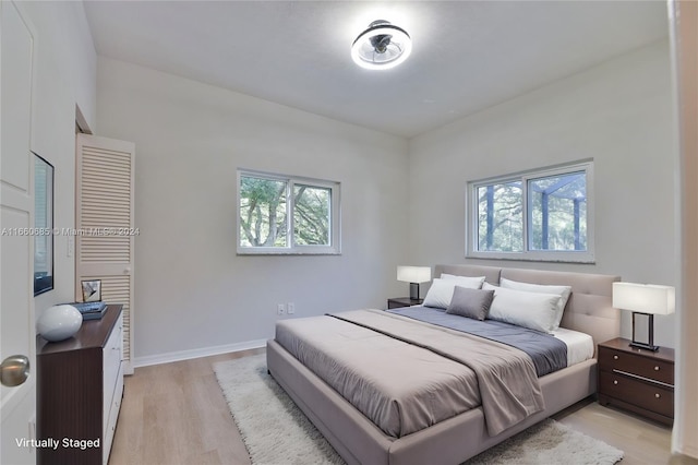 bedroom featuring light hardwood / wood-style flooring and multiple windows