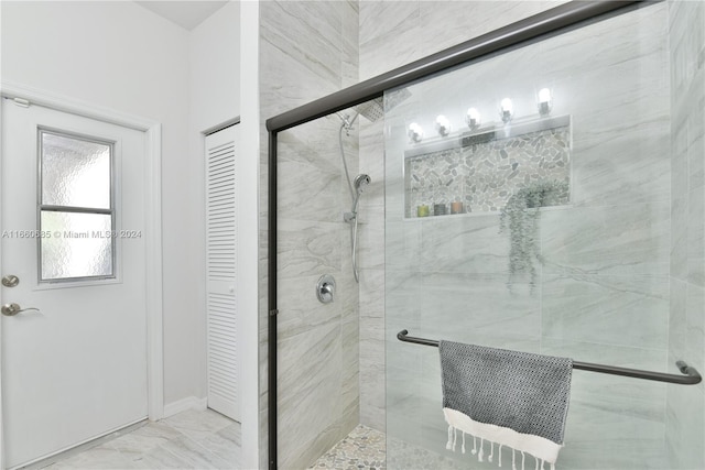 bathroom with a shower with shower door