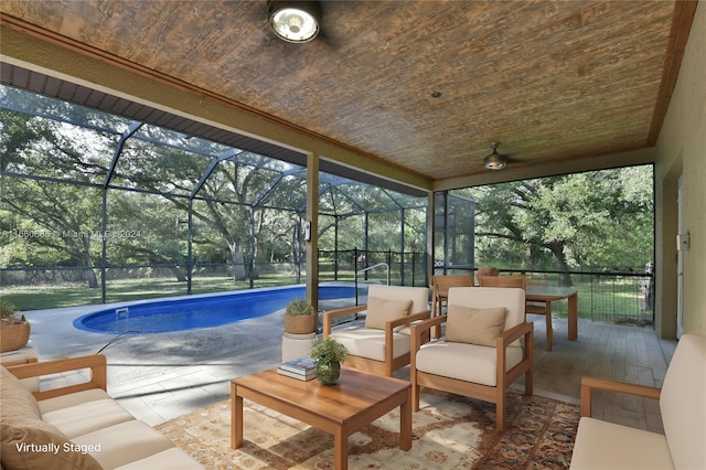 sunroom featuring a swimming pool