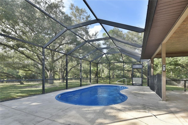 view of pool with a patio area and glass enclosure