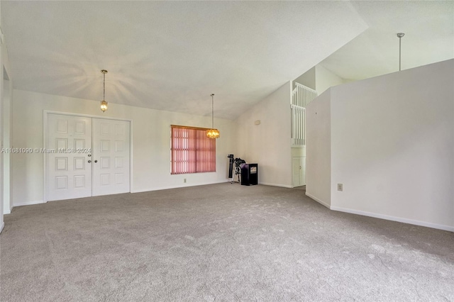 unfurnished living room featuring lofted ceiling and carpet floors