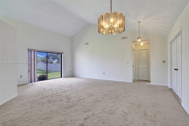 unfurnished room featuring a chandelier, light carpet, and high vaulted ceiling