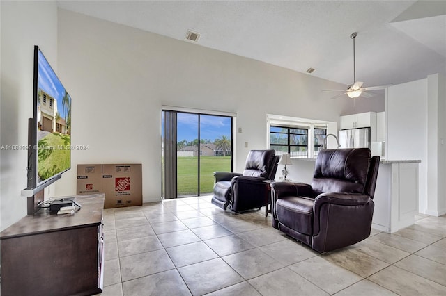 tiled living room featuring a high ceiling and ceiling fan