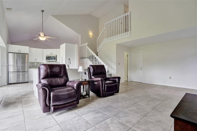 living room featuring light tile patterned flooring, high vaulted ceiling, and ceiling fan