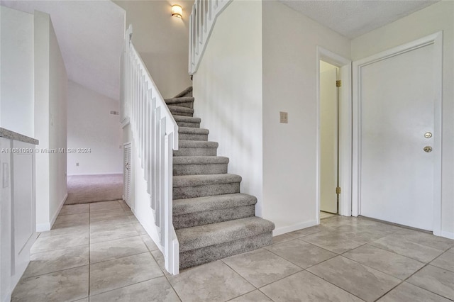 staircase featuring tile patterned floors