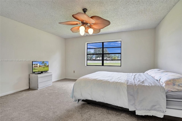 bedroom featuring a textured ceiling, carpet flooring, and ceiling fan