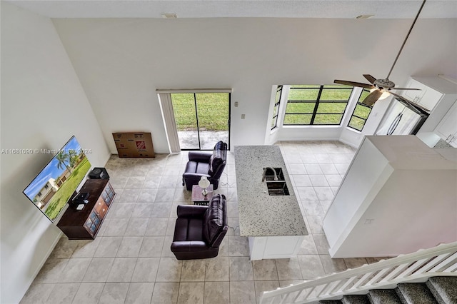 living room with light tile patterned floors and ceiling fan