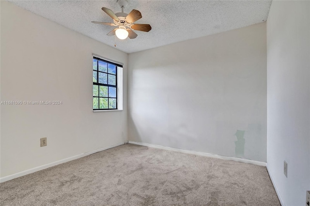 unfurnished room featuring ceiling fan, a textured ceiling, and carpet floors