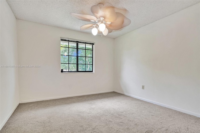 spare room featuring ceiling fan, a textured ceiling, and carpet flooring