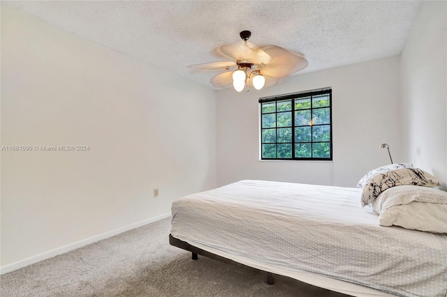 bedroom featuring carpet floors, a textured ceiling, and ceiling fan