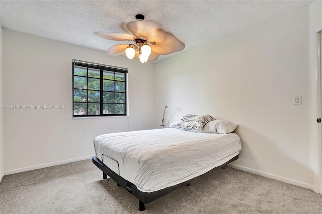 bedroom with light carpet, a textured ceiling, and ceiling fan