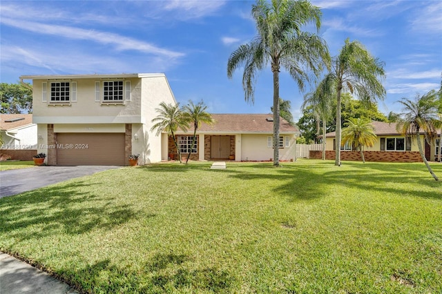 view of front of house featuring a garage and a front lawn