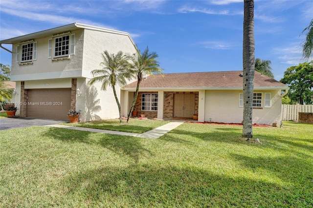 view of front of house featuring a garage and a front lawn