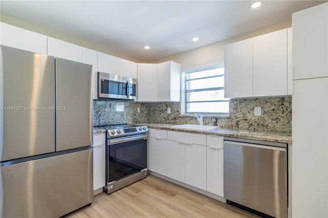 kitchen with sink, white cabinetry, and stainless steel appliances