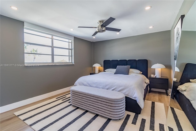 bedroom with light hardwood / wood-style floors and ceiling fan