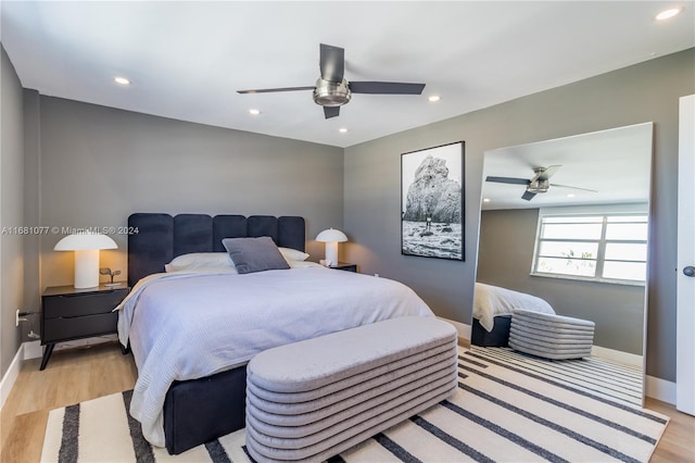 bedroom with light hardwood / wood-style flooring and ceiling fan