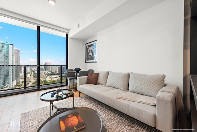 living room with hardwood / wood-style floors and a wall of windows